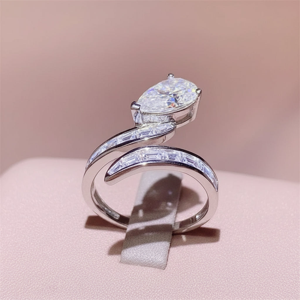 Silver ring with a pear shaped moissanite stone