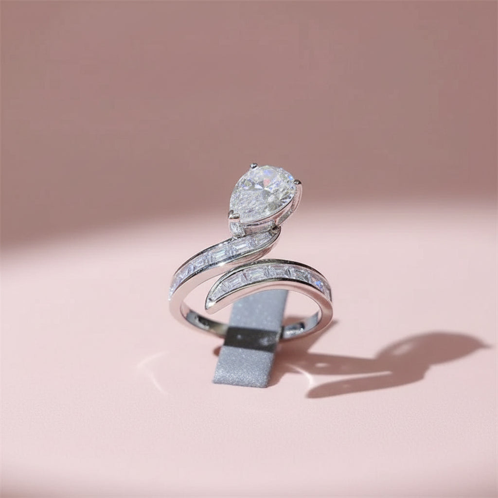 Silver ring with a pear shaped moissanite stone