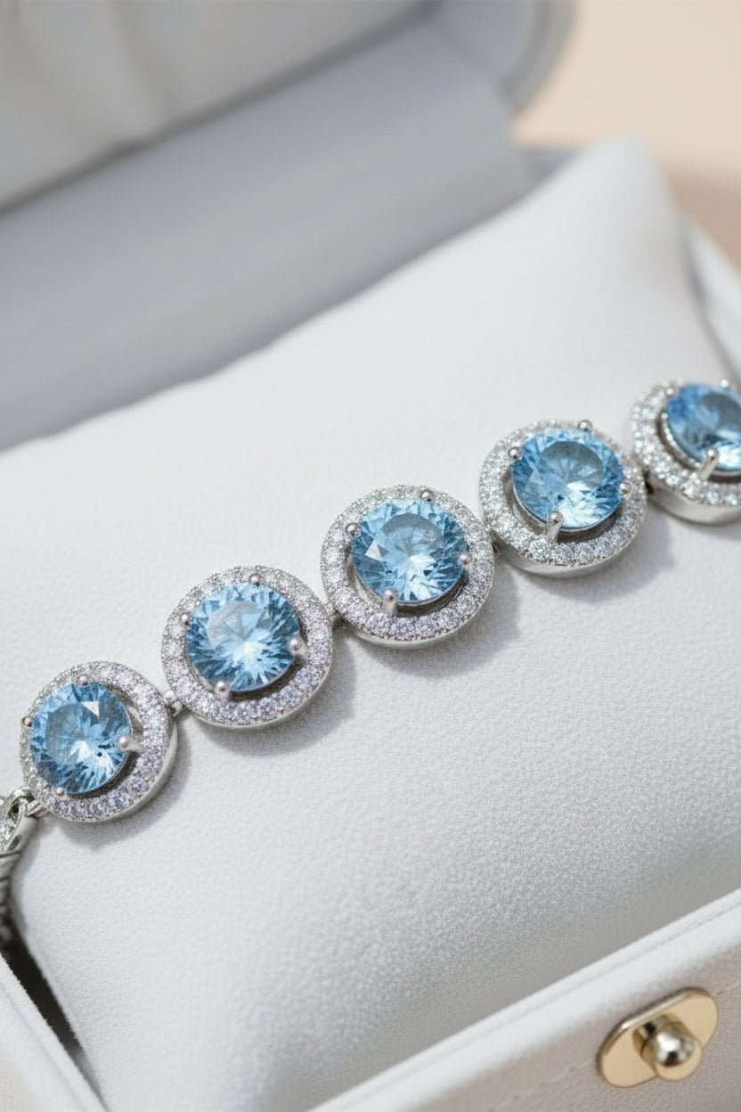 Silver bracelet with blue gemstones and moissanite stones.