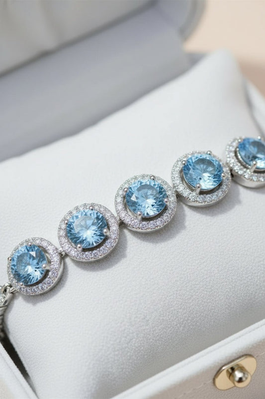 Silver bracelet with blue gemstones and moissanite stones.