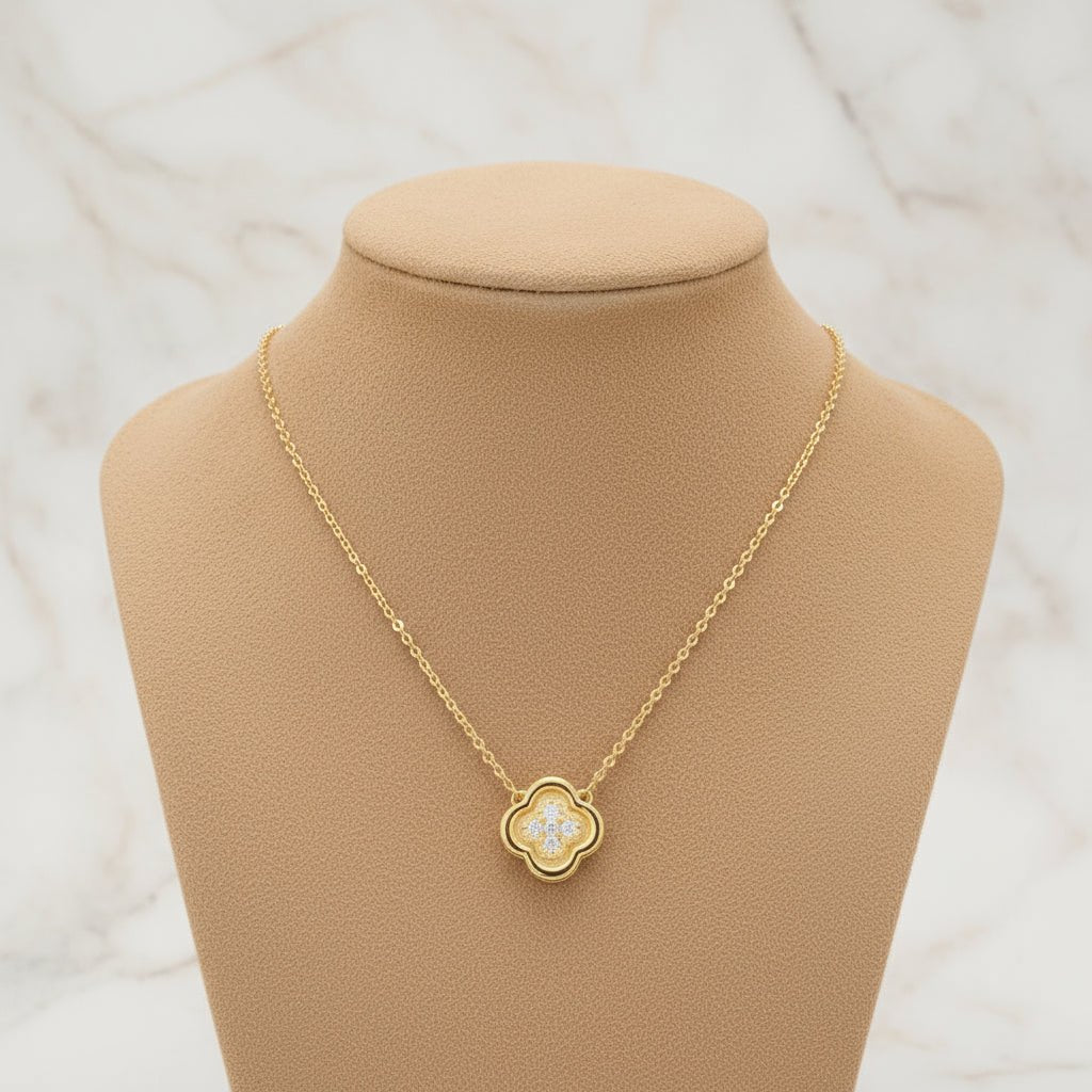 Gold necklace with a clover shaped pendant