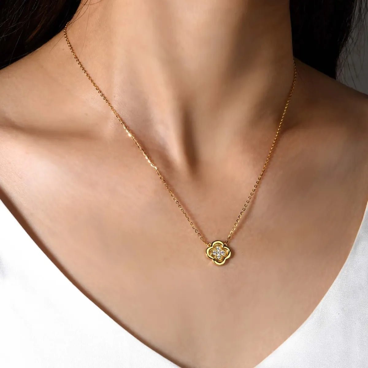 Gold necklace with a clover shaped pendant